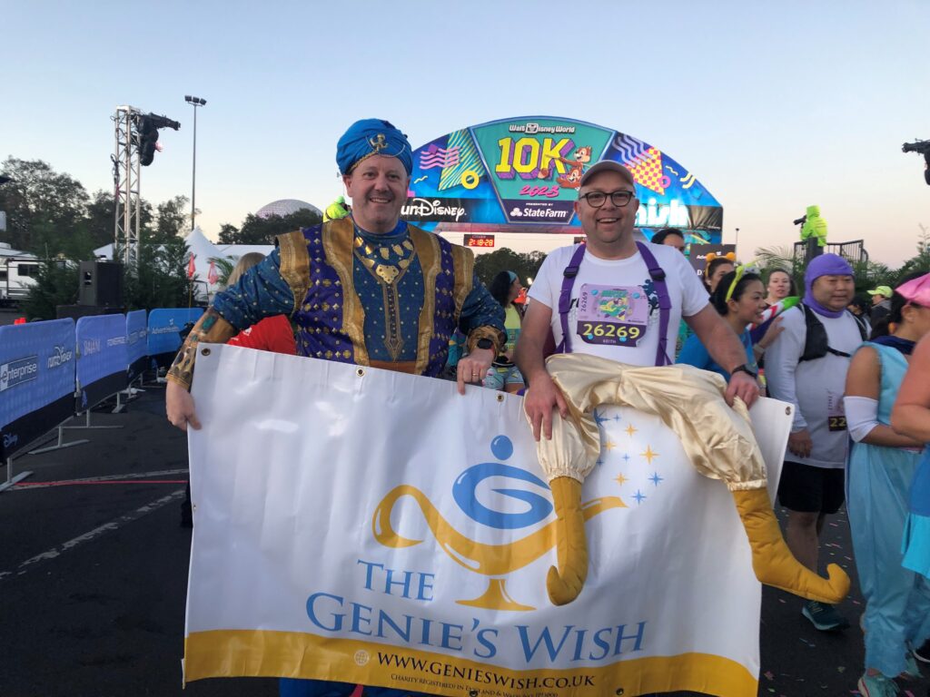 Runners pose after completing the Walt Disney World 10k, running in aid of the Genie's Wish Charity
