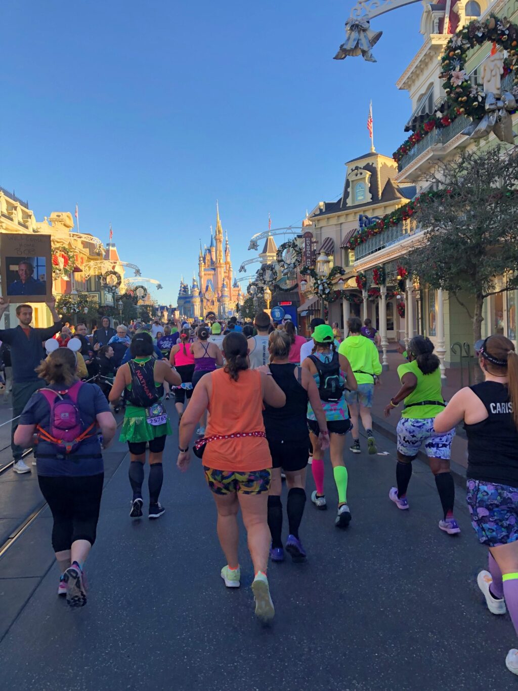 Runners participating in the Disney Marathon heading down Main Street of the Disney Kingdom.